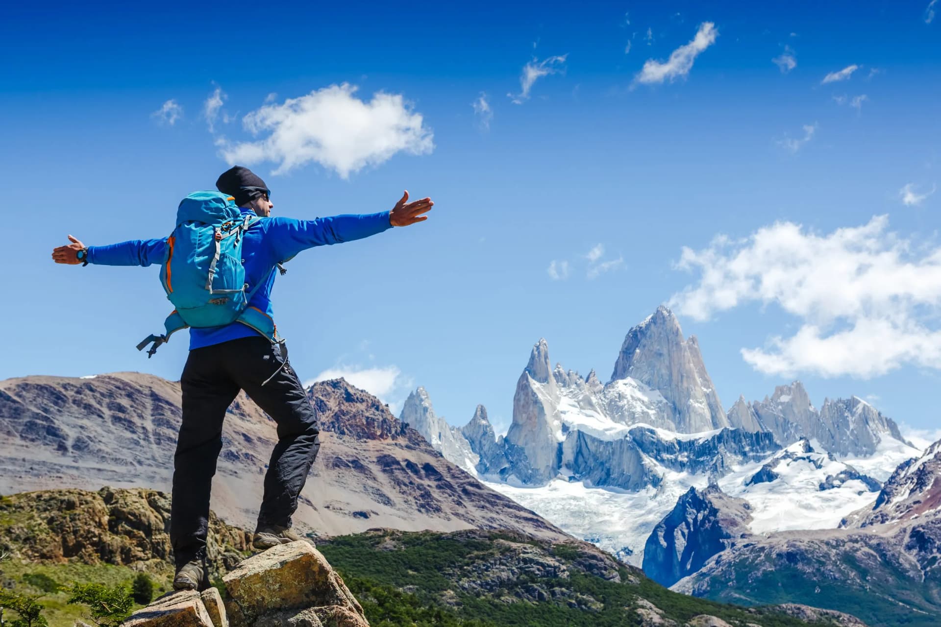 Active hiker hiking, enjoying the view, looking at Patagonia mountain landscape. Fitz Roy, Argentina. Mountaineering sport lifestyle concept